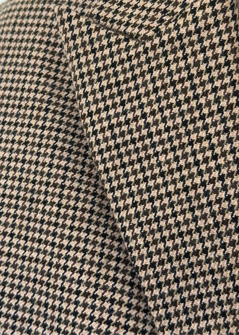 Close-up of the Brock blazer houndstooth fabric with a stitched seam through the pattern