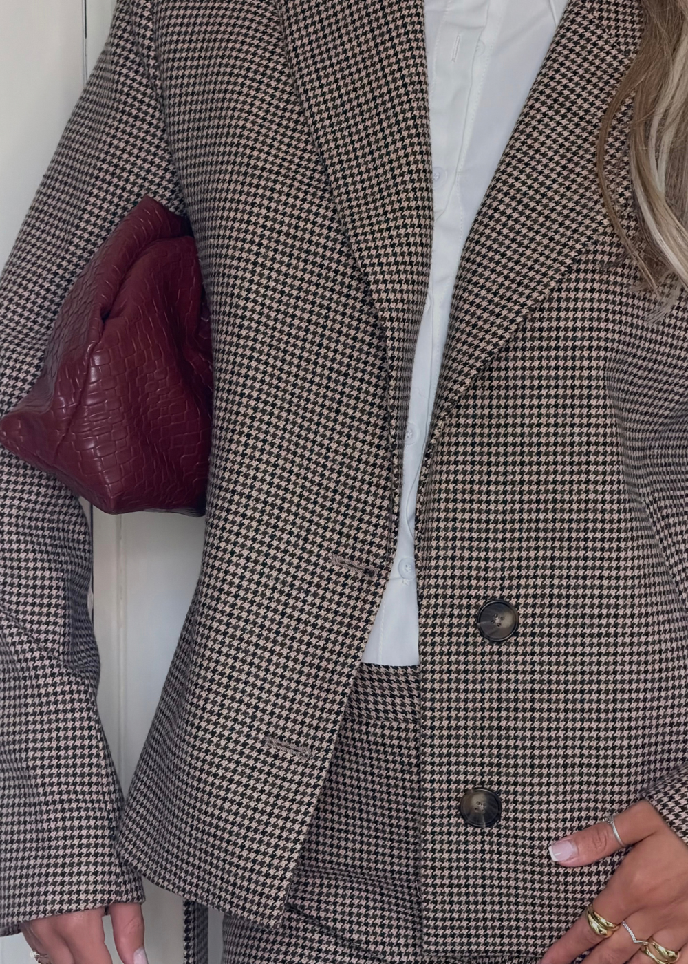 Close view of the Brock blazer showing its houndstooth pattern, lapels and two front buttons
