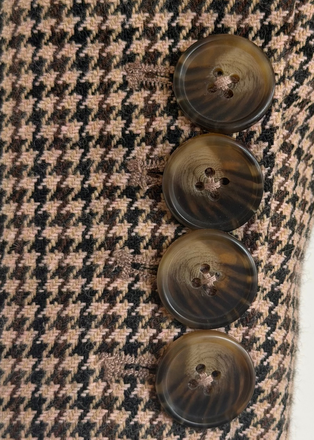 Close-up of four buttons along the Brock blazer sleeve cuff against the houndstooth fabric
